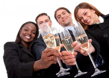 business team at a party over a white background - focus is on glasses
